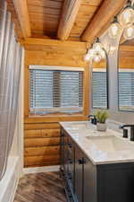 Bathroom with shower / bath combo, hardwood / wood-style floors, vanity, wooden ceiling, and beamed ceiling