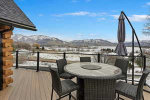 Snow covered deck with a mountain view