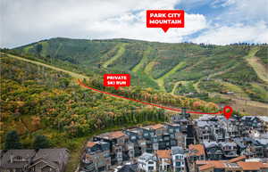 View of property location featuring mountains and a heavily wooded area