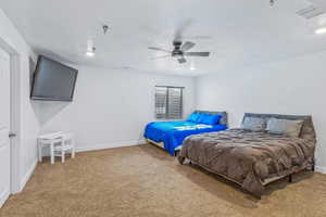 Bedroom featuring ceiling fan, a textured ceiling, and carpet flooring