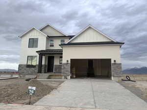 View of front of property with a garage, a mountain view, and a porch