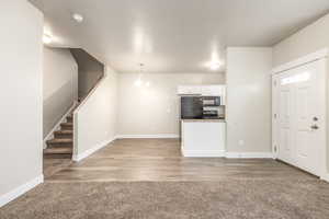 Unfurnished living room featuring light wood-type flooring