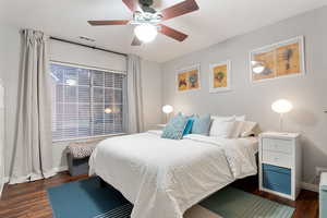 Bedroom featuring dark hardwood / wood-style flooring and ceiling fan