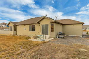 Back of house featuring a patio and a yard