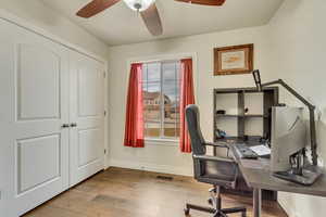 Office with ceiling fan and light wood-type flooring