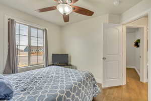 Bedroom featuring ceiling fan and light wood-type flooring