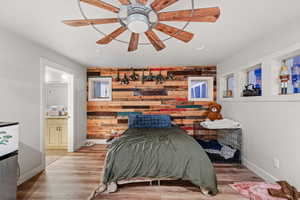 master bedroom with ceiling fan, ensuite bath, light hardwood / wood-style flooring