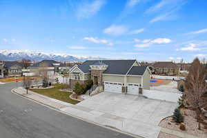 View of front of home featuring a mountain view and a garage