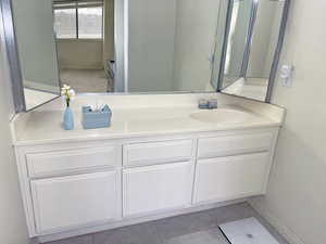 Primary Bathroom with vanity and tile flooring