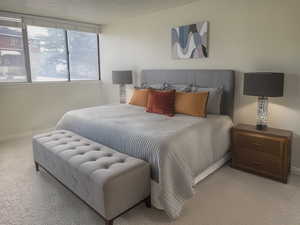 Bedroom featuring light colored carpet