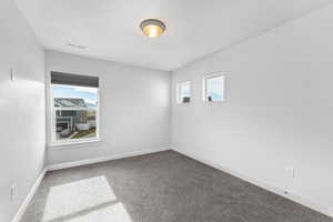 Spare room featuring carpet floors and a textured ceiling