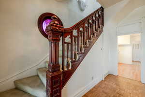 Stairway featuring parquet flooring