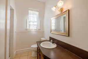 Upstairs Bathroom featuring walk in shower, tile patterned floors, toilet, and vanity