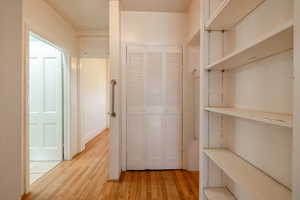 Corridor with light wood-type flooring