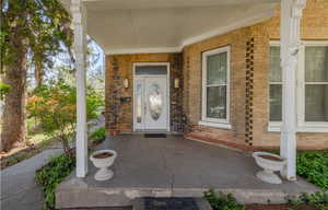 Entrance to property featuring covered porch