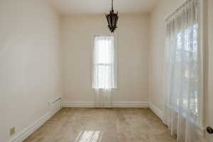 Carpeted empty room featuring a wealth of natural light