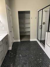 Bathroom featuring vanity and a shower with door