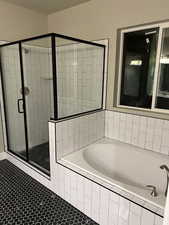 Bathroom featuring tile patterned flooring and plus walk in shower