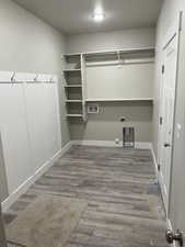 Laundry area featuring hardwood / wood-style flooring, washer hookup, gas dryer hookup, and electric dryer hookup