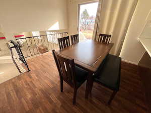 Dining area with dark hardwood / wood-style flooring