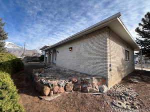 View of side of home with a mountain view