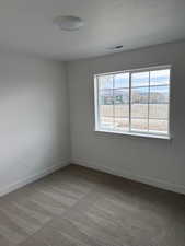 Unfurnished room with plenty of natural light and carpet