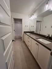 Full bathroom featuring vanity, toilet, shower / washtub combination, and tile patterned flooring