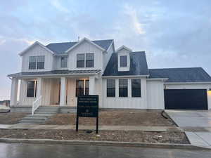 Modern farmhouse style home with a garage and covered porch