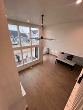 Unfurnished living room featuring hardwood / wood-style floors and ceiling fan