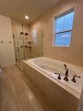 Bathroom with independent shower and bath and tile walls