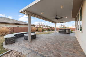 View of patio featuring, ceiling fan, an outdoor kitchen, and a gas fire pit