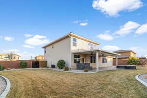 Rear view of property with ceiling fan, central air condition unit, a patio, and a lawn