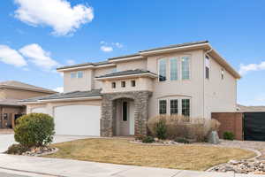 View of front of house featuring a garage and a front lawn