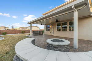 View of patio with ceiling fan, exterior kitchen, and a gas fire pit