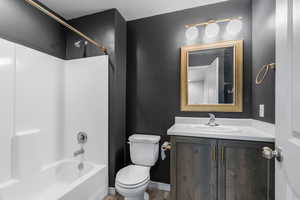 Full bathroom featuring shower / washtub combination, toilet, and vanity