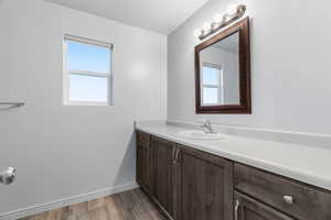 Full Bathroom with hardwood / wood-style flooring and vanity