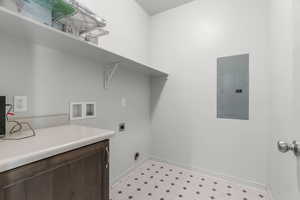 Laundry area with hookup for a washing machine, electric dryer hookup, and electric panel