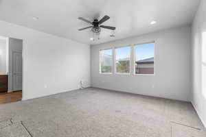 Unfurnished room with ceiling fan and carpet floors