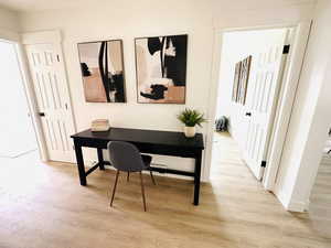 Office area with light wood-type flooring