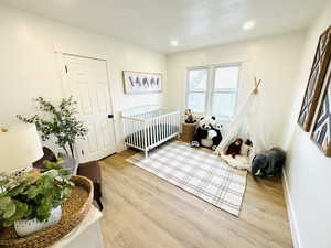 Bedroom with light hardwood / wood-style flooring