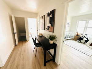 Corridor with light hardwood / wood-style floors