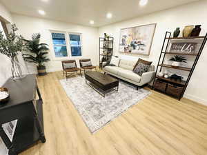 Living room with light hardwood / wood-style flooring