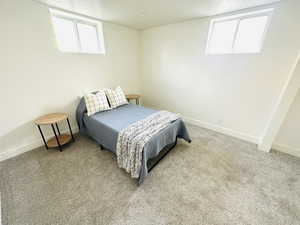 Bedroom featuring light colored carpet