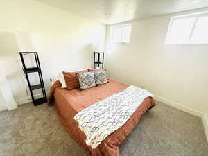 Bedroom with a textured ceiling and carpet flooring