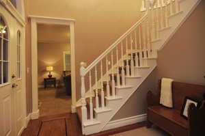 Staircase with hardwood / wood-style floors