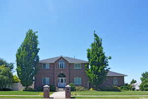 Colonial-style house with a front lawn