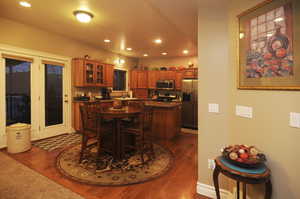 Dining room with dark hardwood / wood-style floors and sink