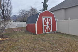 View of outdoor structure with a yard