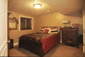 Carpeted bedroom featuring a textured ceiling