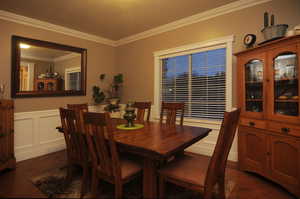 Dining room with crown molding and dark hardwood / wood-style floors